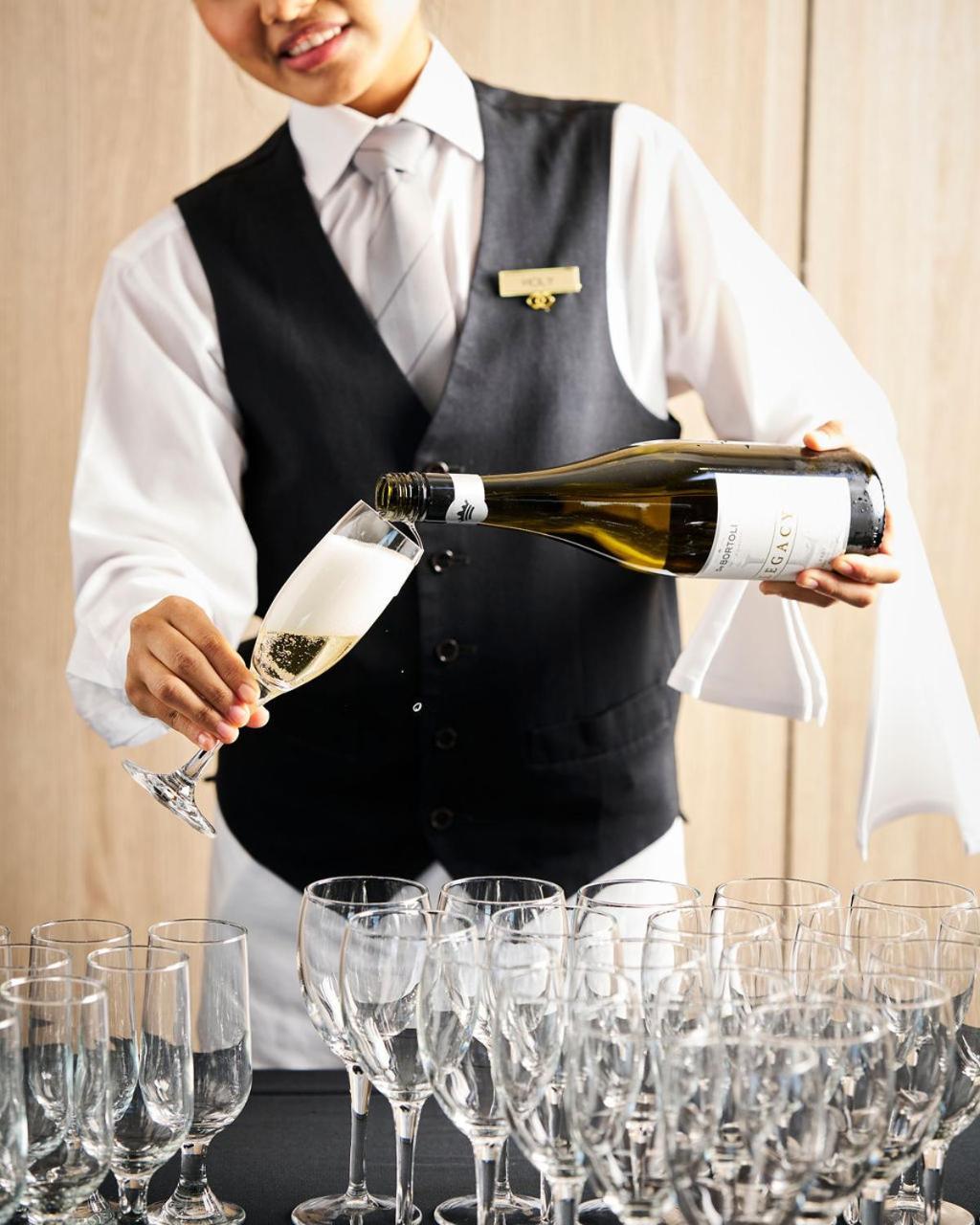 Sofitel Melbourne On Collins Hotel Exterior photo A sommelier pouring champagne