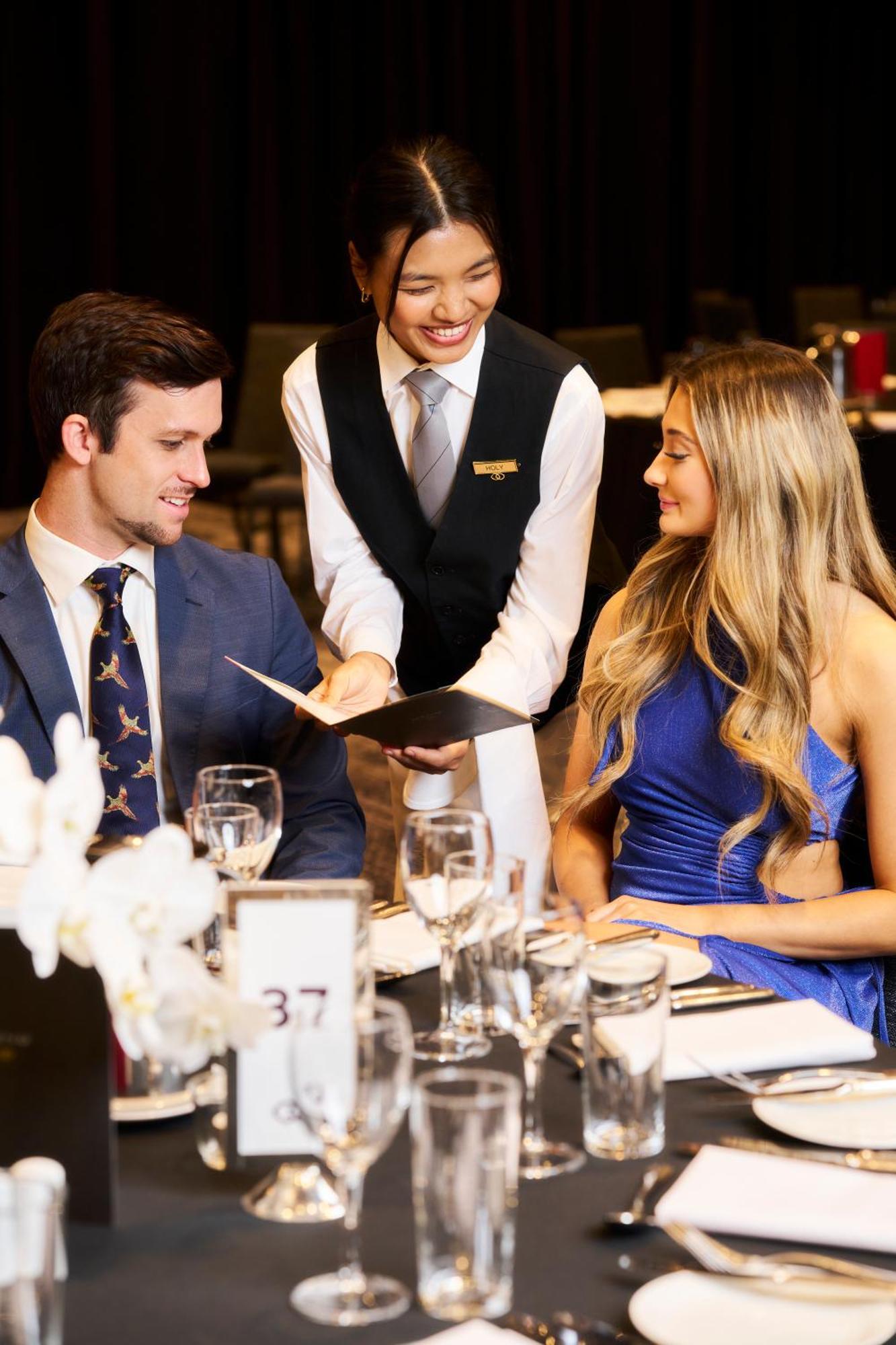 Sofitel Melbourne On Collins Hotel Exterior photo A waiter serving a couple